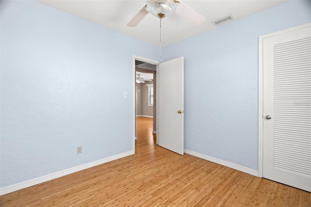 unfurnished bedroom featuring visible vents, baseboards, ceiling fan, and light wood finished floors