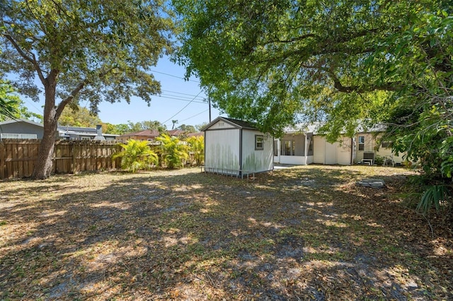 view of yard featuring an outbuilding and fence