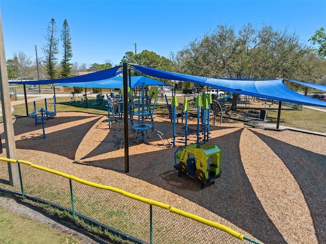 community jungle gym featuring fence