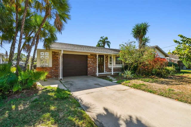 view of front of home with concrete driveway, brick siding, and a garage