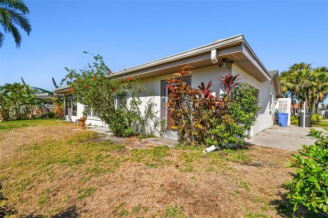 exterior space featuring a yard and stucco siding