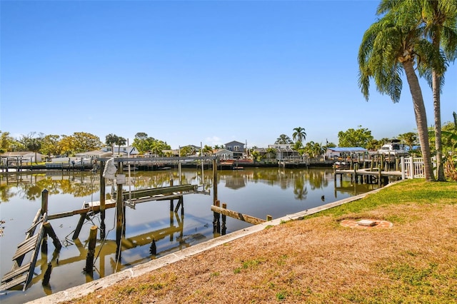 view of dock featuring a water view, a residential view, and boat lift