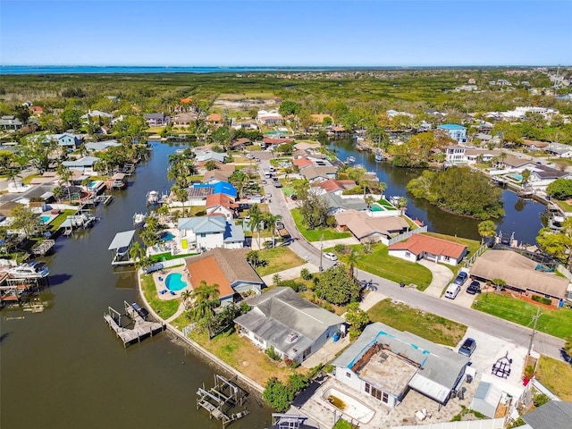 drone / aerial view featuring a residential view and a water view