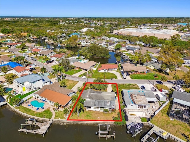 drone / aerial view featuring a residential view and a water view