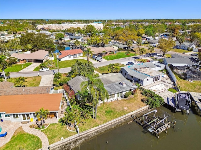 drone / aerial view with a residential view and a water view