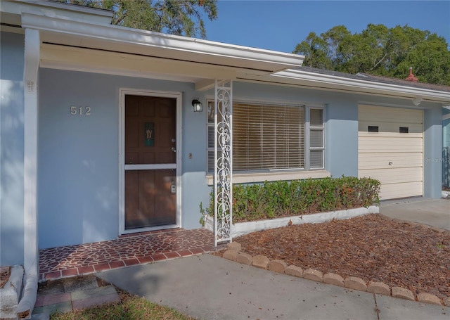 entrance to property with stucco siding