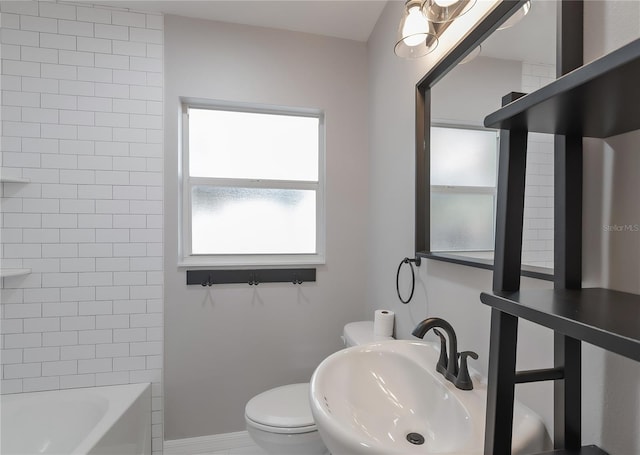 full bath with a sink, shower / bath combination, baseboards, and toilet