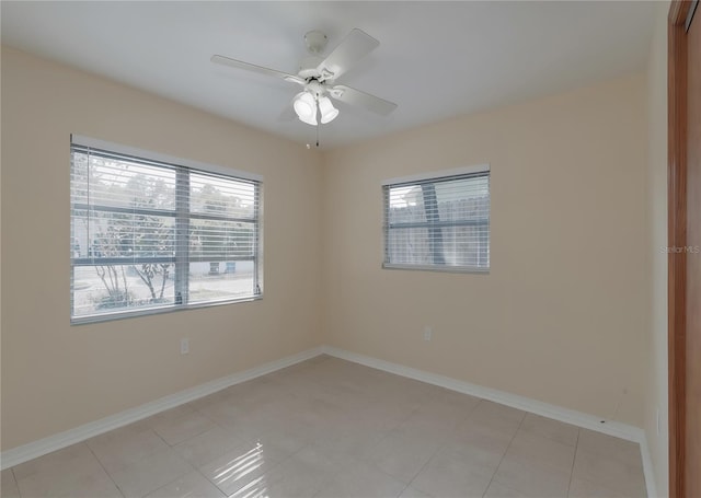 unfurnished room featuring a ceiling fan and baseboards