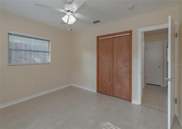 unfurnished bedroom featuring baseboards, visible vents, and a closet