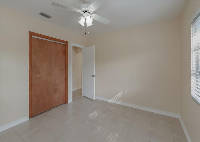 unfurnished bedroom with a ceiling fan, baseboards, visible vents, and a closet