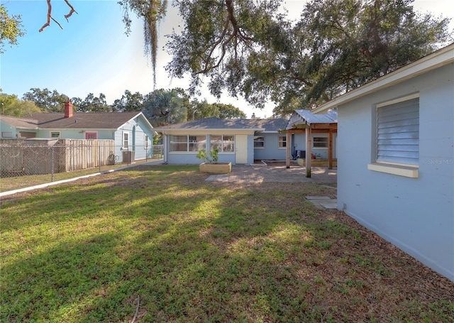 view of yard with a sunroom and fence