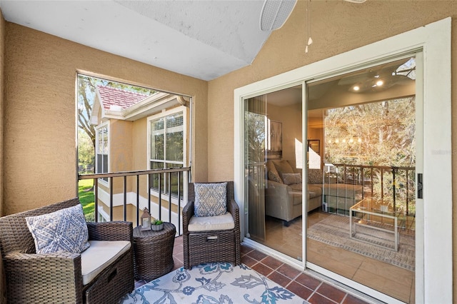 sunroom featuring a ceiling fan and vaulted ceiling