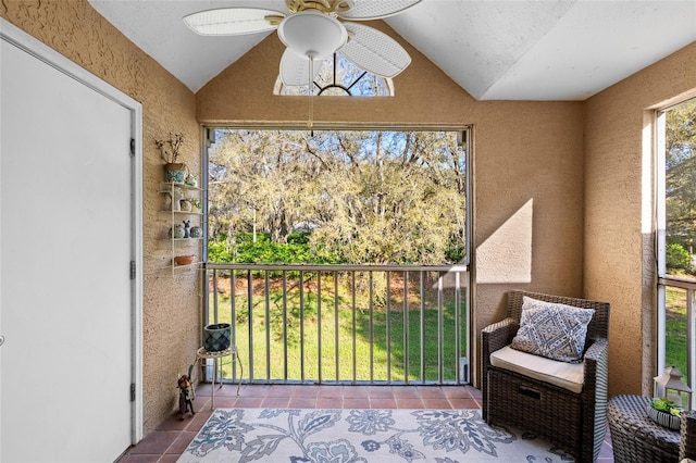 sunroom with lofted ceiling and a ceiling fan