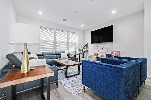 living area with recessed lighting and wood finished floors