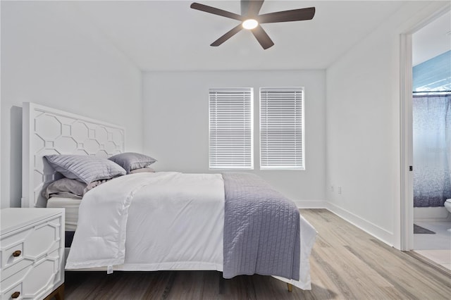 bedroom with a ceiling fan, wood finished floors, and baseboards