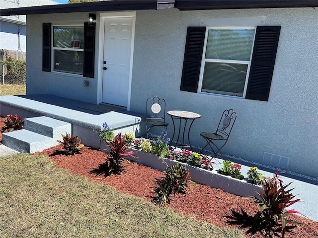 doorway to property with stucco siding