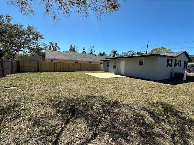 view of yard featuring a patio, central AC unit, and a fenced backyard