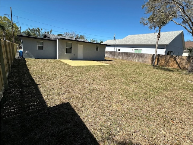 view of yard featuring a patio area and a fenced backyard