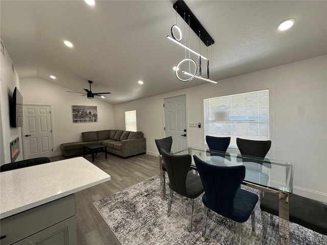 dining room featuring recessed lighting, wood finished floors, and vaulted ceiling