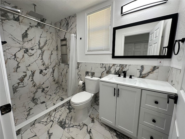 bathroom with toilet, vanity, a stall shower, marble finish floor, and a textured ceiling