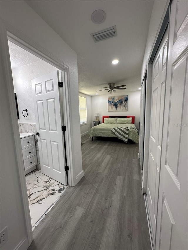 bedroom with wood finished floors, visible vents, baseboards, recessed lighting, and ceiling fan