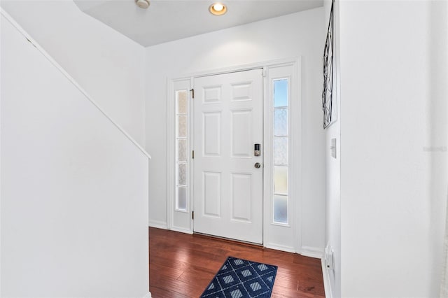 foyer with a healthy amount of sunlight, baseboards, and hardwood / wood-style flooring