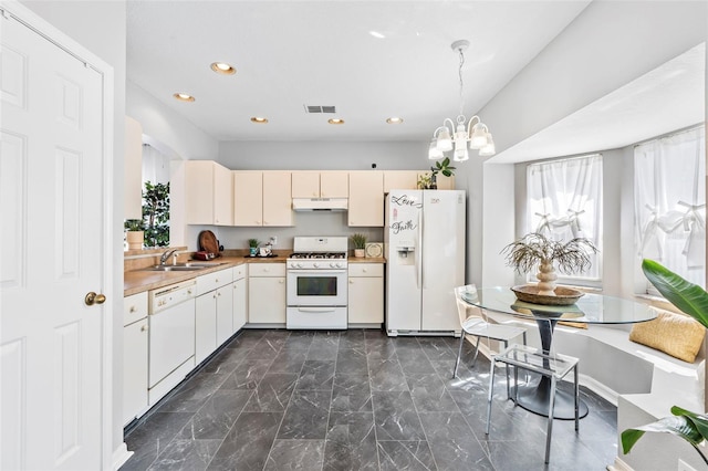 kitchen with visible vents, under cabinet range hood, a chandelier, white appliances, and a sink