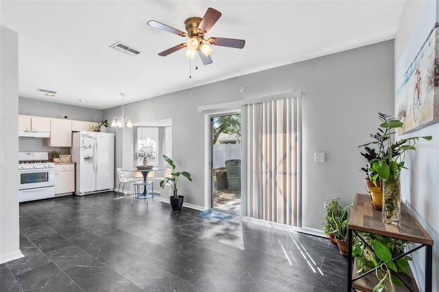 interior space with visible vents, baseboards, and ceiling fan with notable chandelier