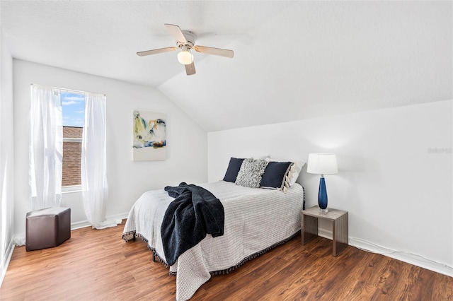 bedroom featuring vaulted ceiling, baseboards, ceiling fan, and wood finished floors