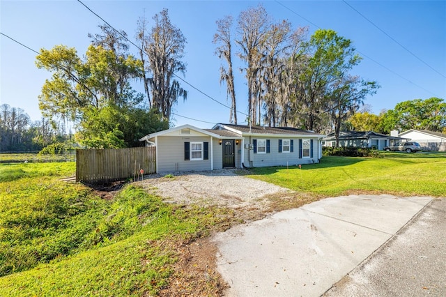 view of front of home with a front lawn and fence