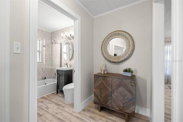 full bath featuring vanity, wood finished floors, baseboards, ornamental molding, and toilet