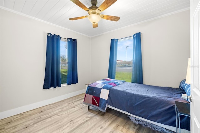 bedroom with crown molding, ceiling fan, baseboards, wood ceiling, and wood finished floors