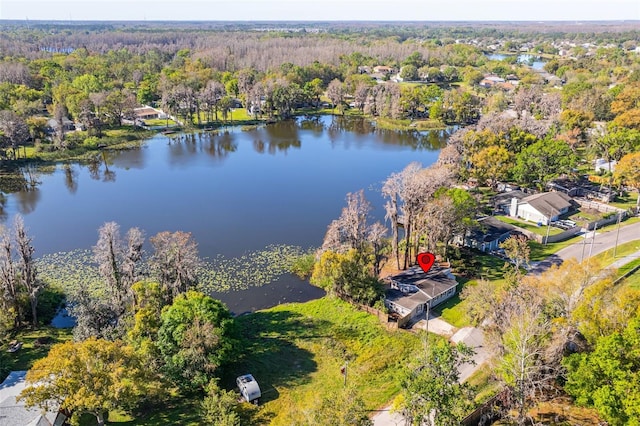 aerial view featuring a view of trees and a water view