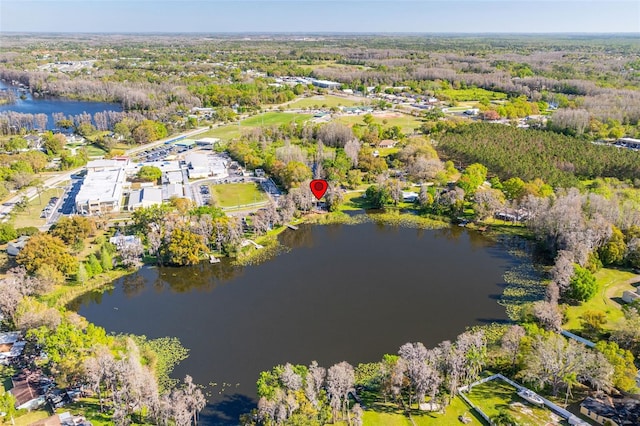 birds eye view of property with a forest view and a water view