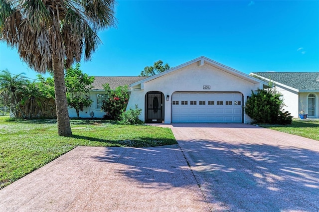 ranch-style home with stucco siding, driveway, a garage, and a front lawn