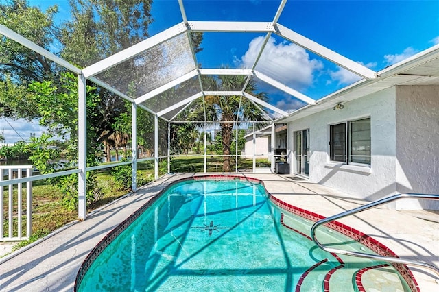 outdoor pool featuring a lanai and a patio area