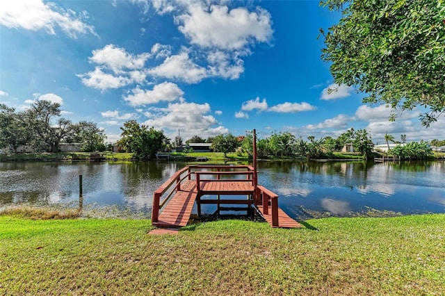 dock area featuring a lawn and a water view