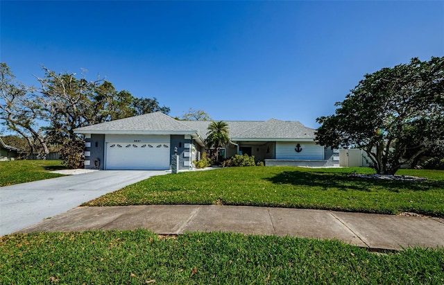 ranch-style home with an attached garage, a shingled roof, driveway, and a front lawn