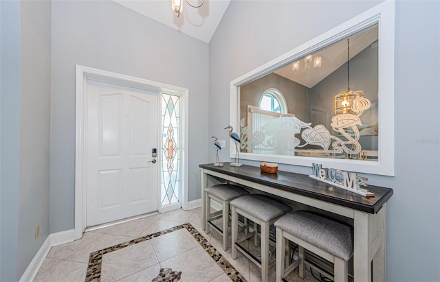 entrance foyer featuring lofted ceiling and baseboards