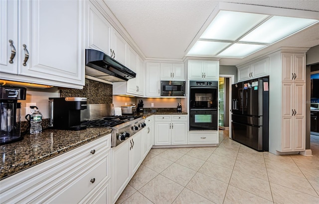 kitchen featuring under cabinet range hood, black appliances, light tile patterned flooring, and white cabinetry