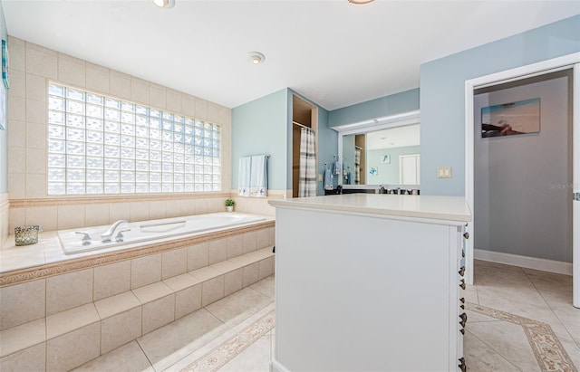 bathroom with tile patterned flooring, a garden tub, vanity, and a shower with shower curtain