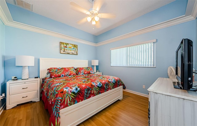 bedroom with a ceiling fan, light wood-type flooring, and baseboards