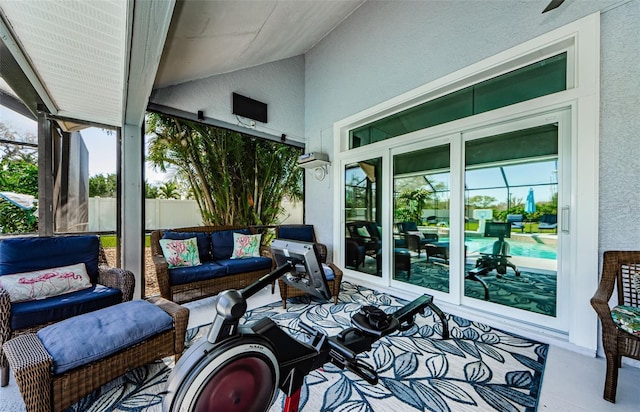 sunroom with a healthy amount of sunlight and lofted ceiling