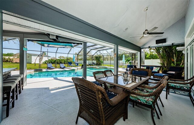 view of pool featuring a patio area, a pool with connected hot tub, a lanai, and ceiling fan