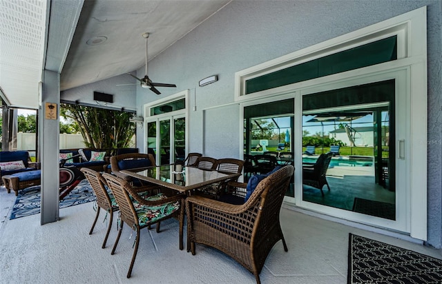 view of patio featuring ceiling fan, outdoor dining space, and fence