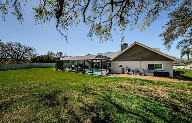 back of property featuring a fenced in pool, a lanai, a lawn, a chimney, and a fenced backyard