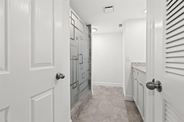 full bathroom featuring visible vents, a shower stall, vanity, and baseboards