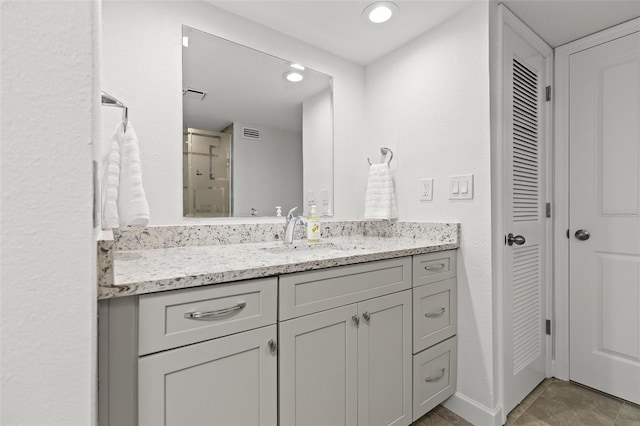 bathroom with visible vents, recessed lighting, a closet, baseboards, and vanity