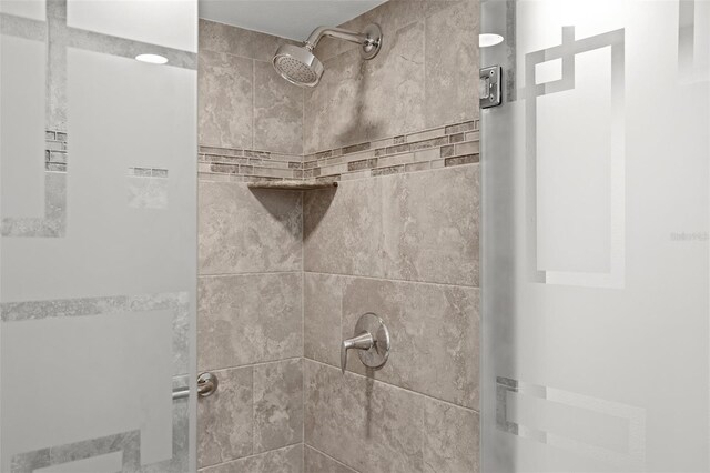 full bathroom featuring water heater and tiled shower