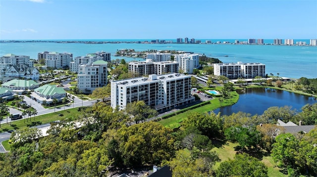 drone / aerial view featuring a view of city and a water view